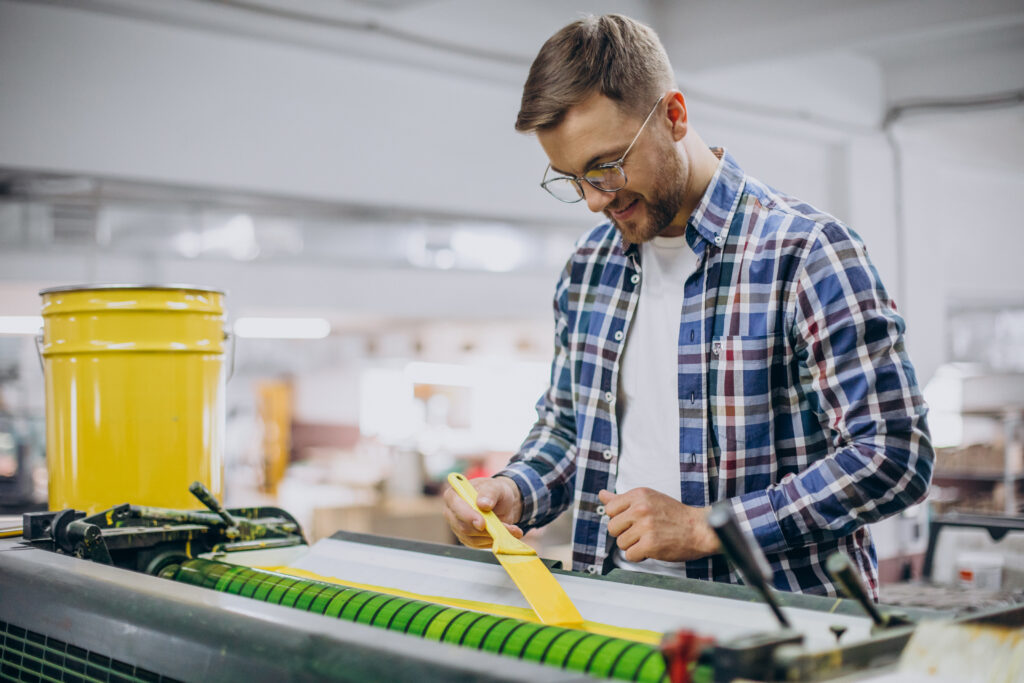 man working printing house with paper paints 1